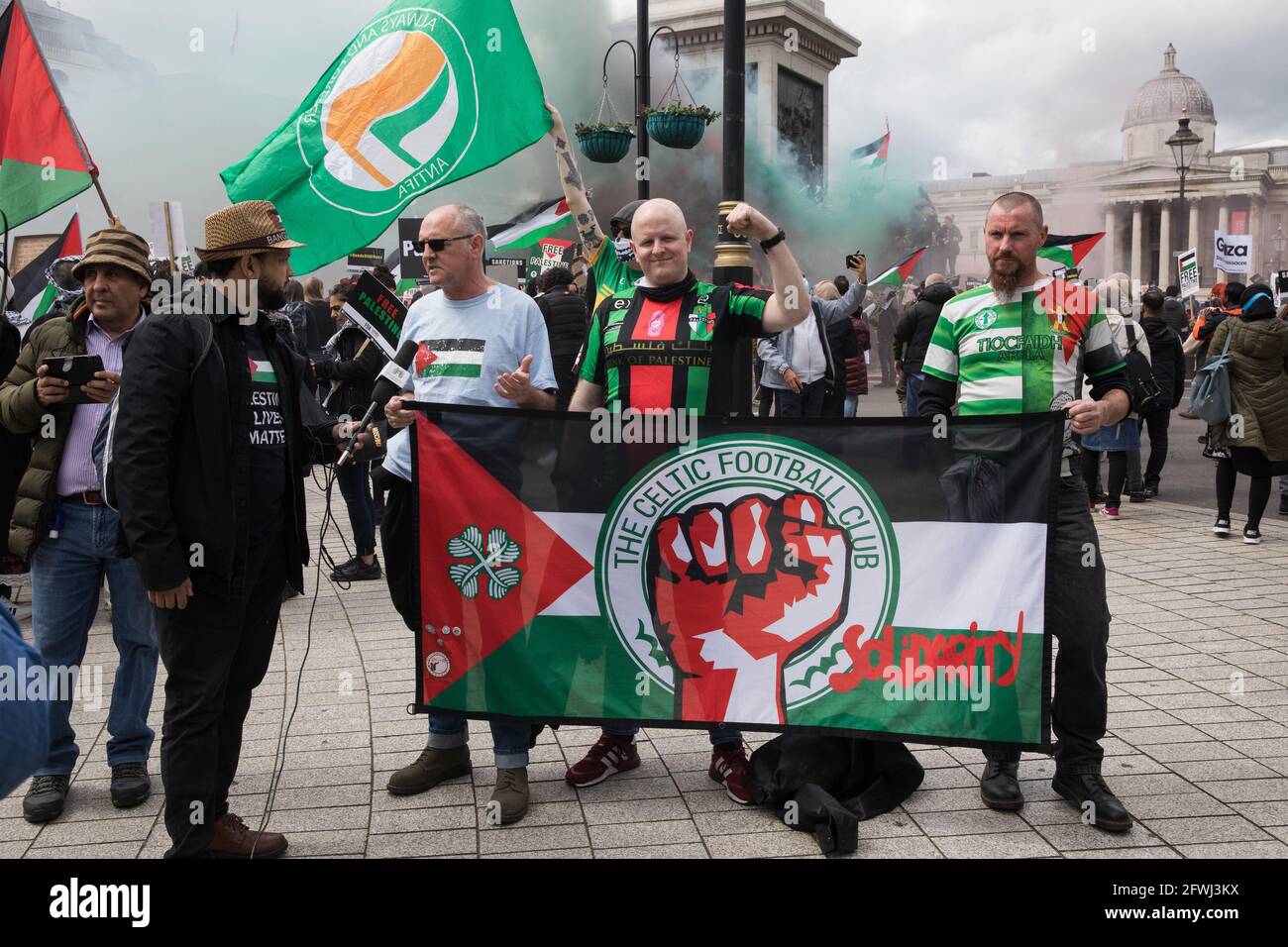 London, UK. 22 May, 2021. Celtic FC fans, well-known for their support of the Palestinian cause, join tens of thousands of people taking part in the National Demonstration for Palestine. It was organised by pro-Palestinian solidarity groups in protest against Israel's recent attacks on Gaza, its incursions at the Al-Aqsa mosque and its attempts to forcibly displace Palestinian families from the Sheikh Jarrah neighbourhood of East Jerusalem. Credit: Mark Kerrison/Alamy Live News Stock Photo