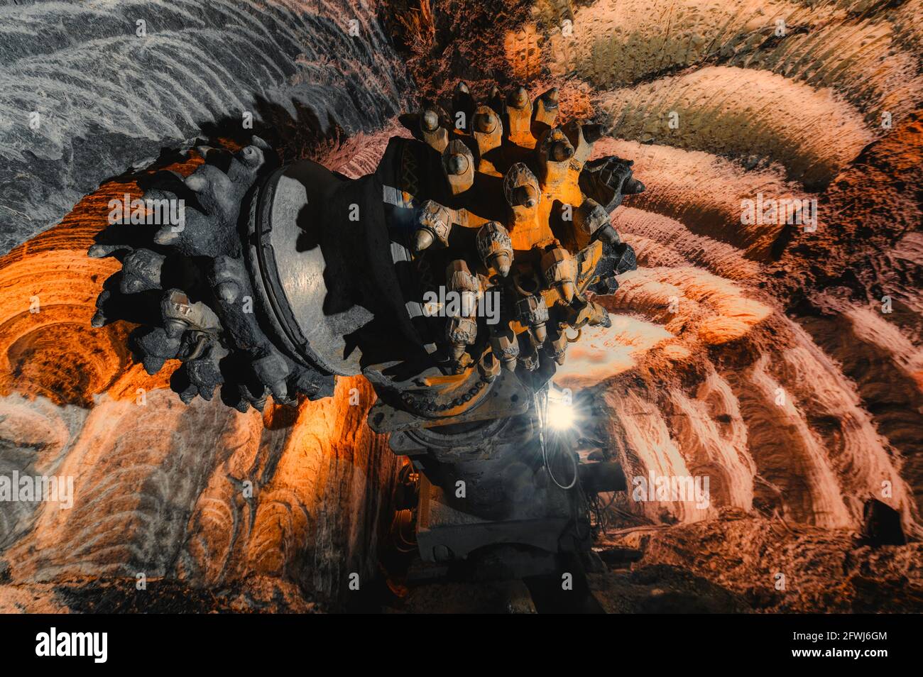 The drill head of a mine roadheader closeup. The drill is equipped