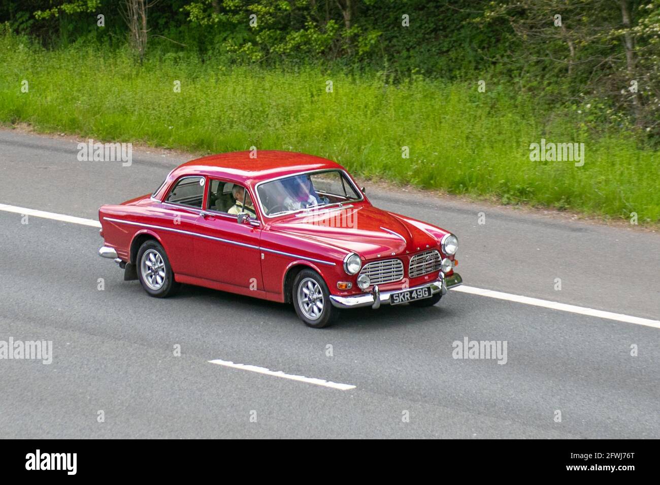 1968 60s red Swedish Volvo 123 Gt 1780cc retro 4dr saloon,  Vehicular traffic, moving vehicles, foreign cars, vehicle driving on UK roads, motors, motoring on the M6 motorway highway UK road network. Stock Photo
