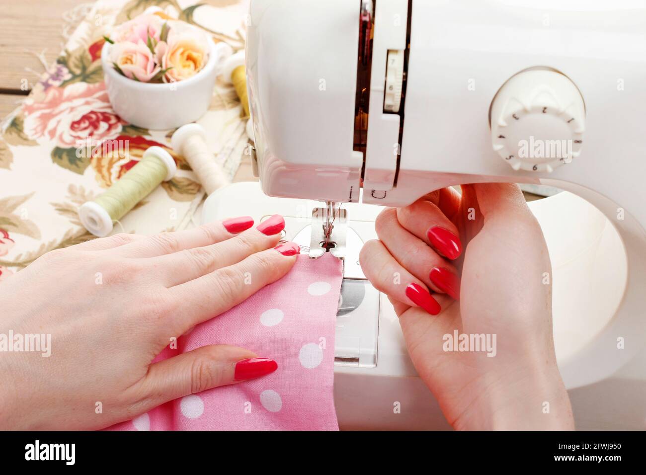 Woman works with sewing machine. Hobby time Stock Photo Alamy