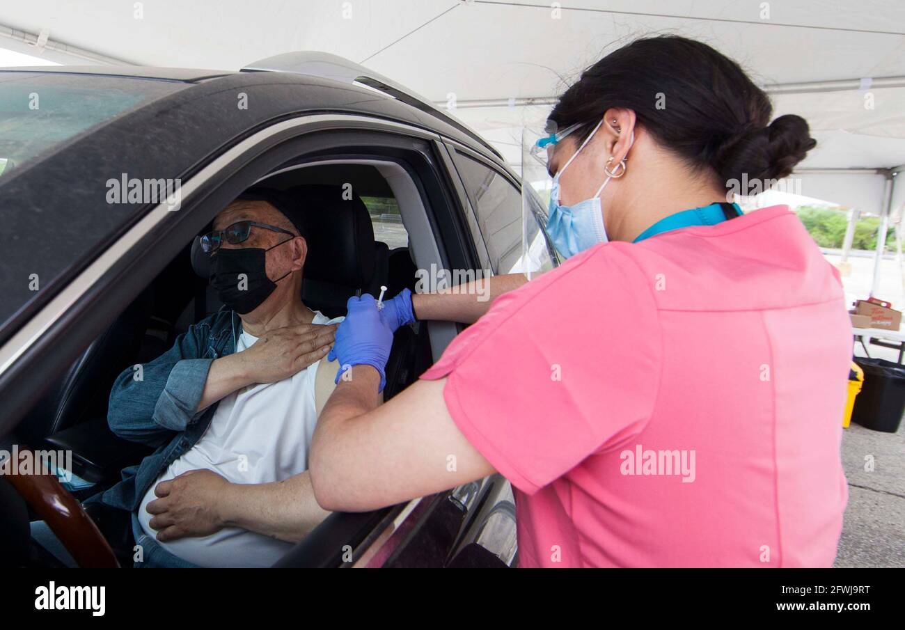 Toronto, Canada. 22nd May, 2021. A man receives a dose of COVID-19 vaccine in his vehicle at a drive-thru vaccination site in Toronto, Canada, on May 22, 2021. About 50.08 percent of Canada's population were administered with the first dose of COVID-19 vaccine and 4.3 percent with second dose as of Saturday afternoon, according to CTV. Credit: Zou Zheng/Xinhua/Alamy Live News Stock Photo