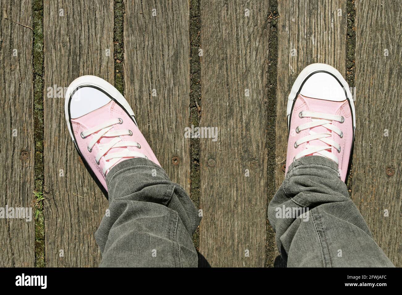 Pink trainers on wooden background. Graphic resources Stock Photo - Alamy