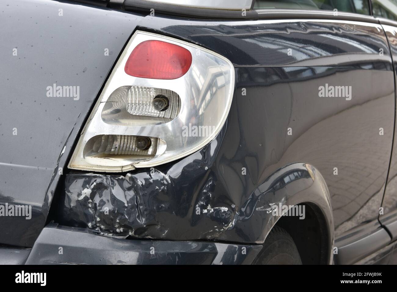Car damages in rear part of the vehicle close up. Stock Photo