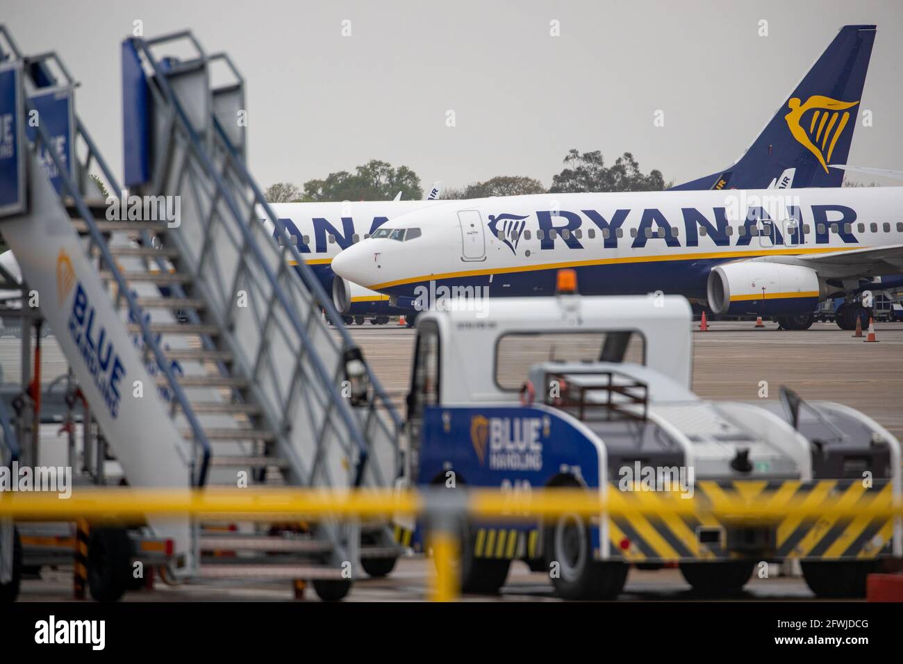 Picture dated May 14th shows Ryanair aircraft and ancillary equipment parked up at Stansted Airport in Essex.Today the company announced losses of £702m.   Ryanair has reported a record annual after-tax loss of £702m today after Covid-19 restrictions forced it to scrap over 80% of flights, but the airline said there were signs the recovery had begun.  Ryanair said it flew 27.5 million passengers in its financial year ended March, down from 149 million the previous year in what it called the most challenging in its history.  The airline reiterated its forecast that passenger numbers for the cur Stock Photo