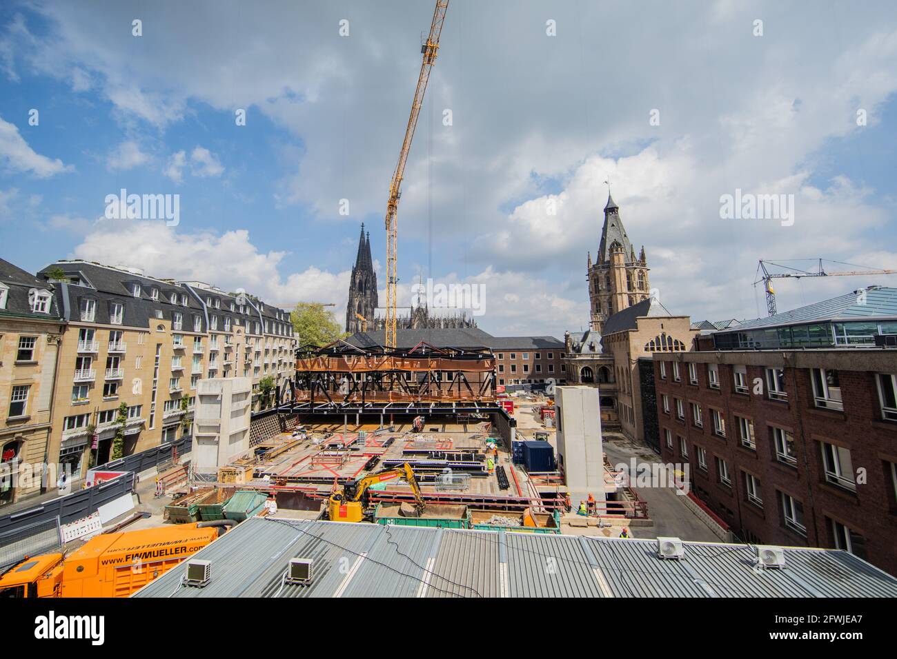 Cologne, Germany. 20th May, 2021. View of the Archaeological Zone - MiQua Jewish Museum construction site - Cologne Cathedral and the Historic Town Hall in the background. A permanent exhibition underground on Rathausplatz shows some of the most important archaeological evidence of Cologne's city history and the Rhineland on a 600-metre-long tour with numerous integrated exhibition areas: the Roman Praetorium, the medieval Jewish quarter and the goldsmiths' quarter. Credit: Rolf Vennenbernd/dpa/Alamy Live News Stock Photo