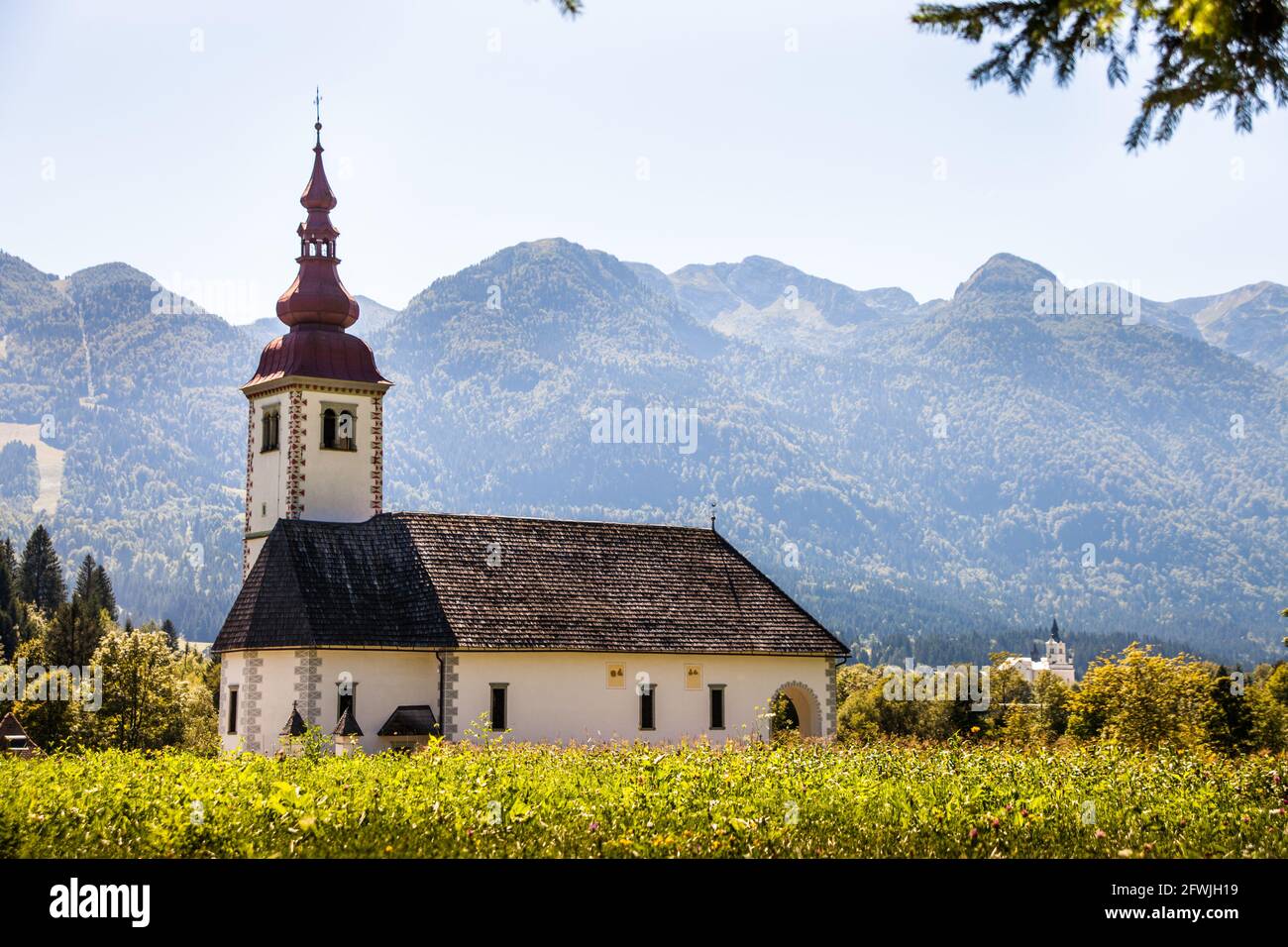 Idyllic church tower at Lake Bohinj, Slovenia Stock Photo