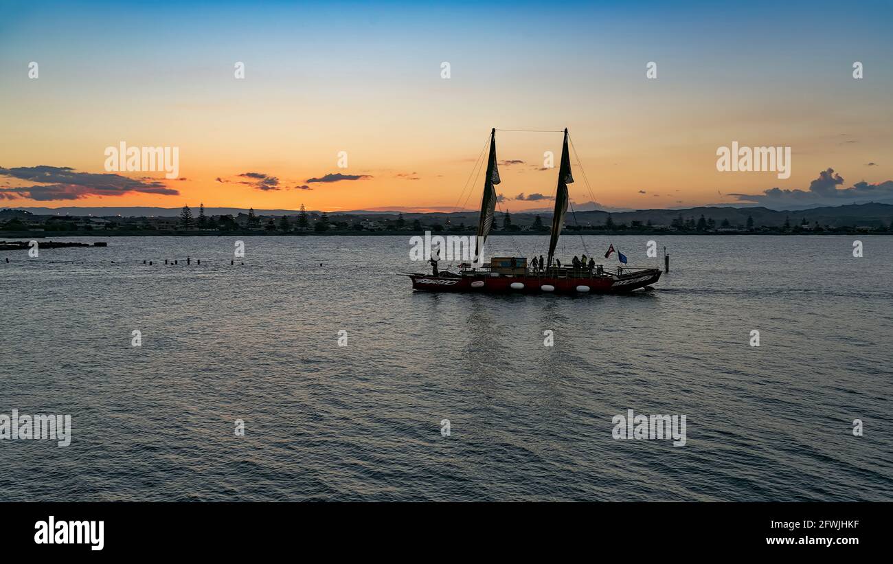 The Sea Walk on the Ancient Maori Sailing Boat in the Evening Stock Photo