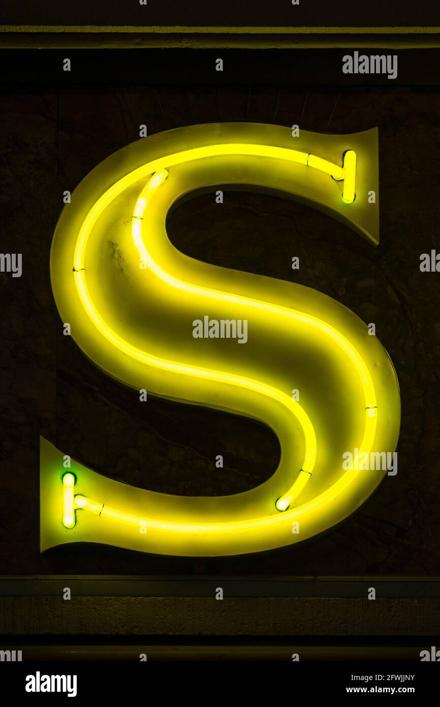Shining yellow neon letter S Stock Photo