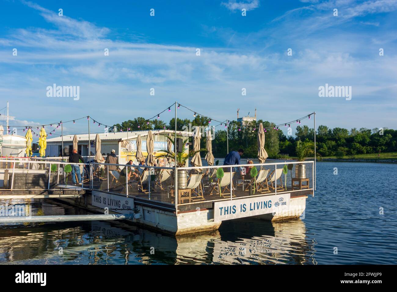 Wien, Vienna: restaurant reopened after closure due to Covid-19, 'This is Living' Corona beer billboard, floating restaurant 'Vienna City Beach Club' Stock Photo