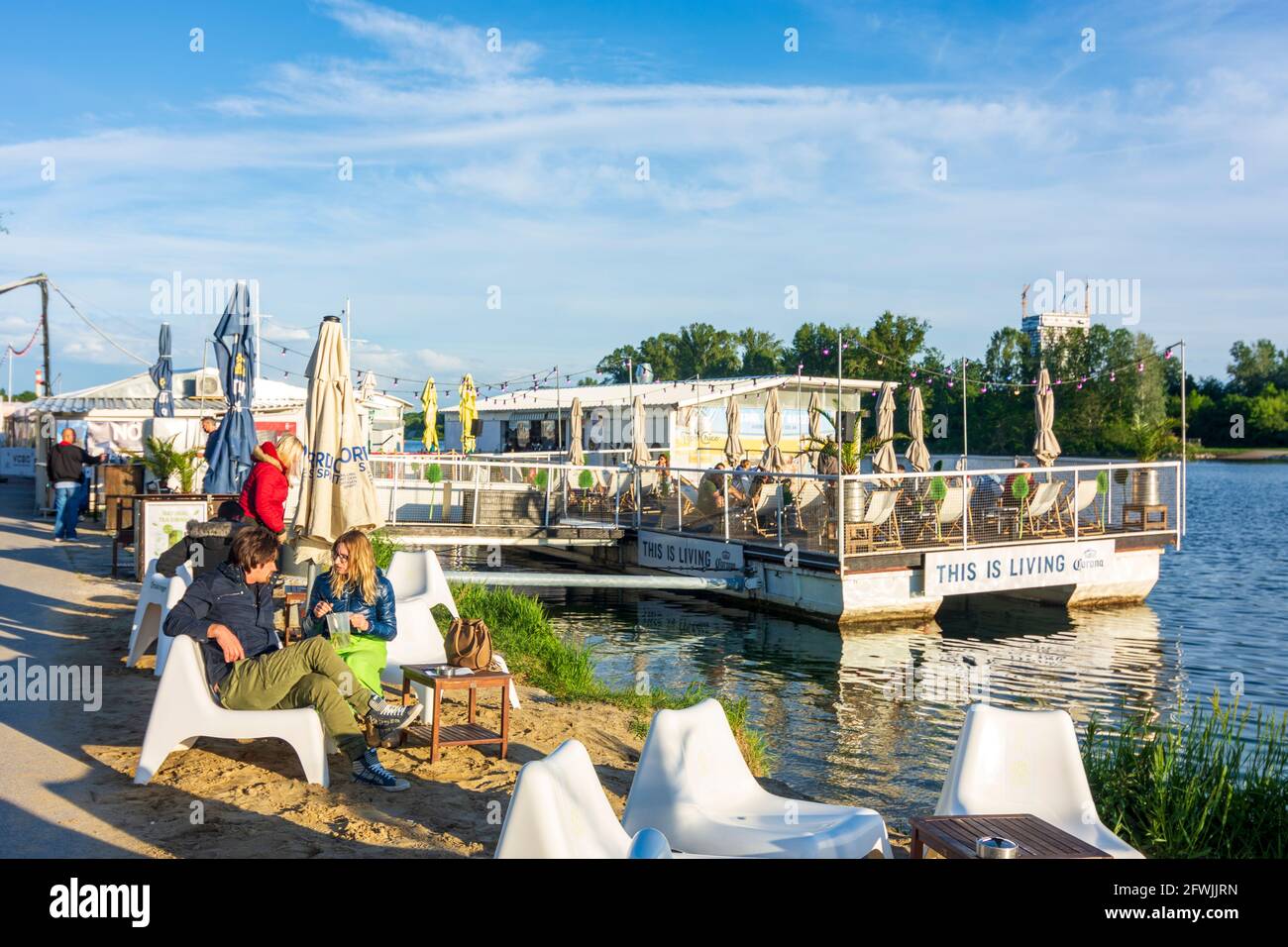 Wien, Vienna: restaurant reopened after closure due to Covid-19, 'This is Living' Corona beer billboard, floating restaurant 'Vienna City Beach Club' Stock Photo