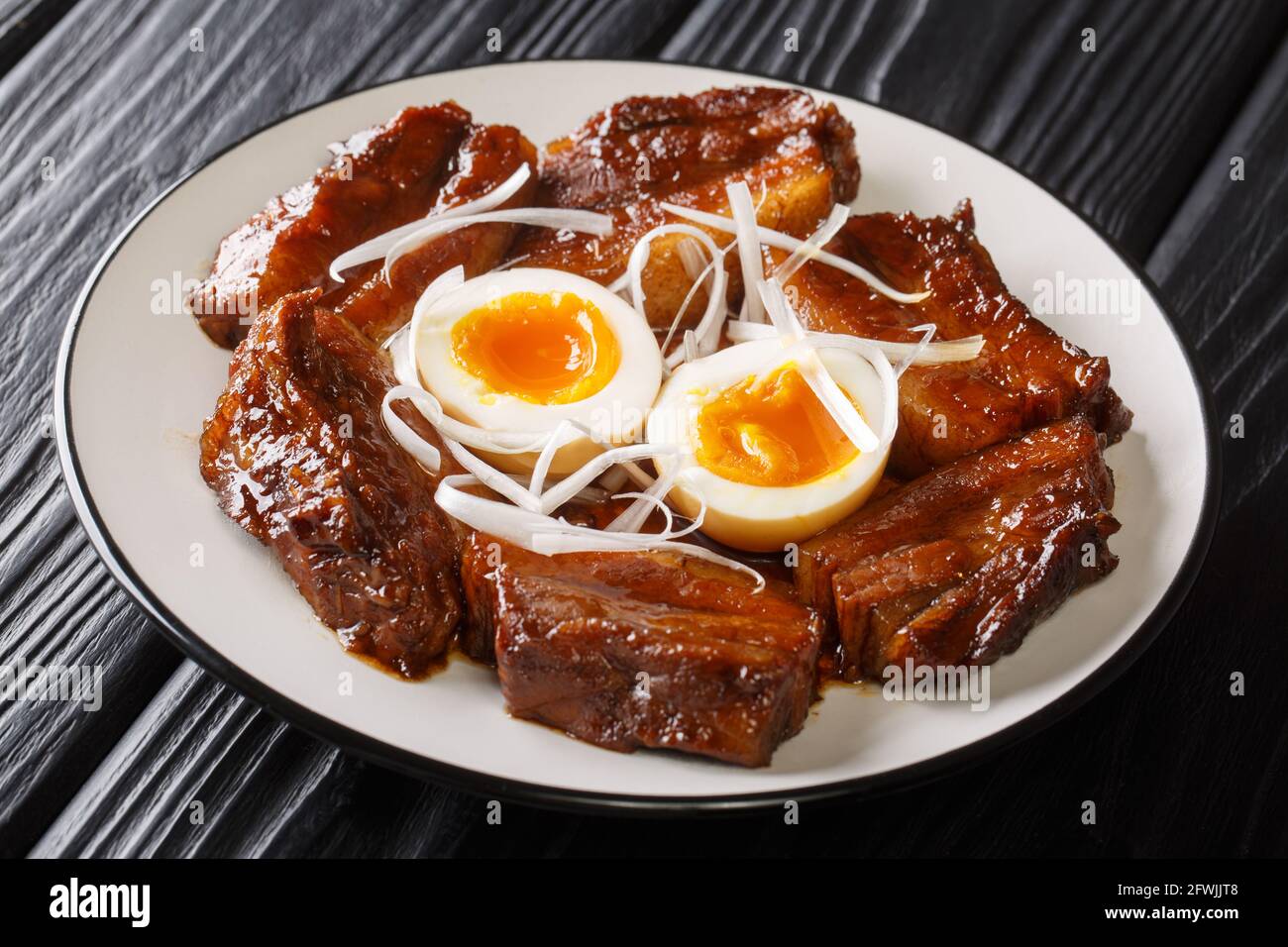 Nagasaki style braised pork belly buta kakuni close up in the plate on