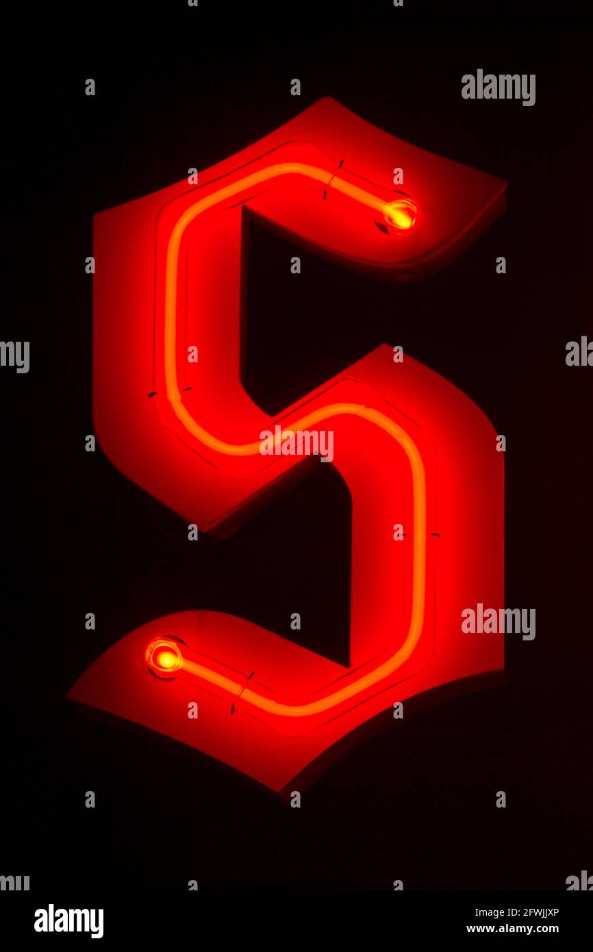 Red glowing neon letter S Stock Photo