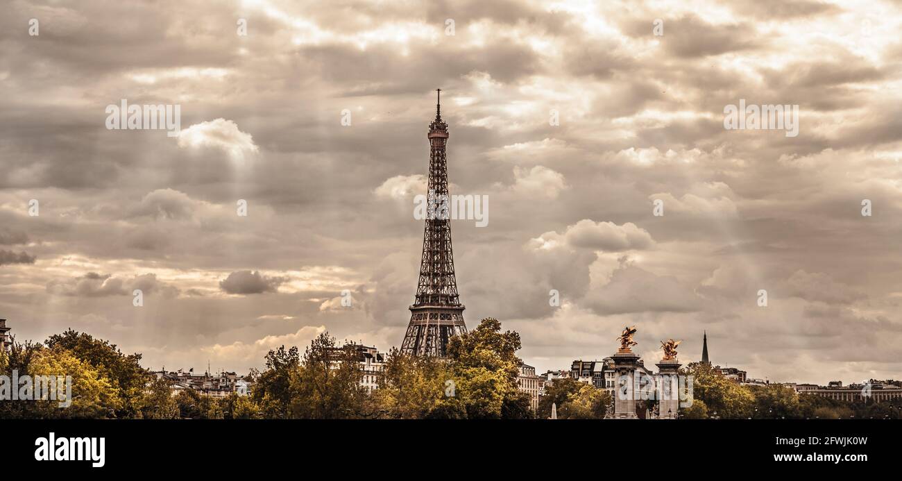 Paris cityscape with the iconic Eiffel tower lit by sun beams. (sepia rendition) Stock Photo