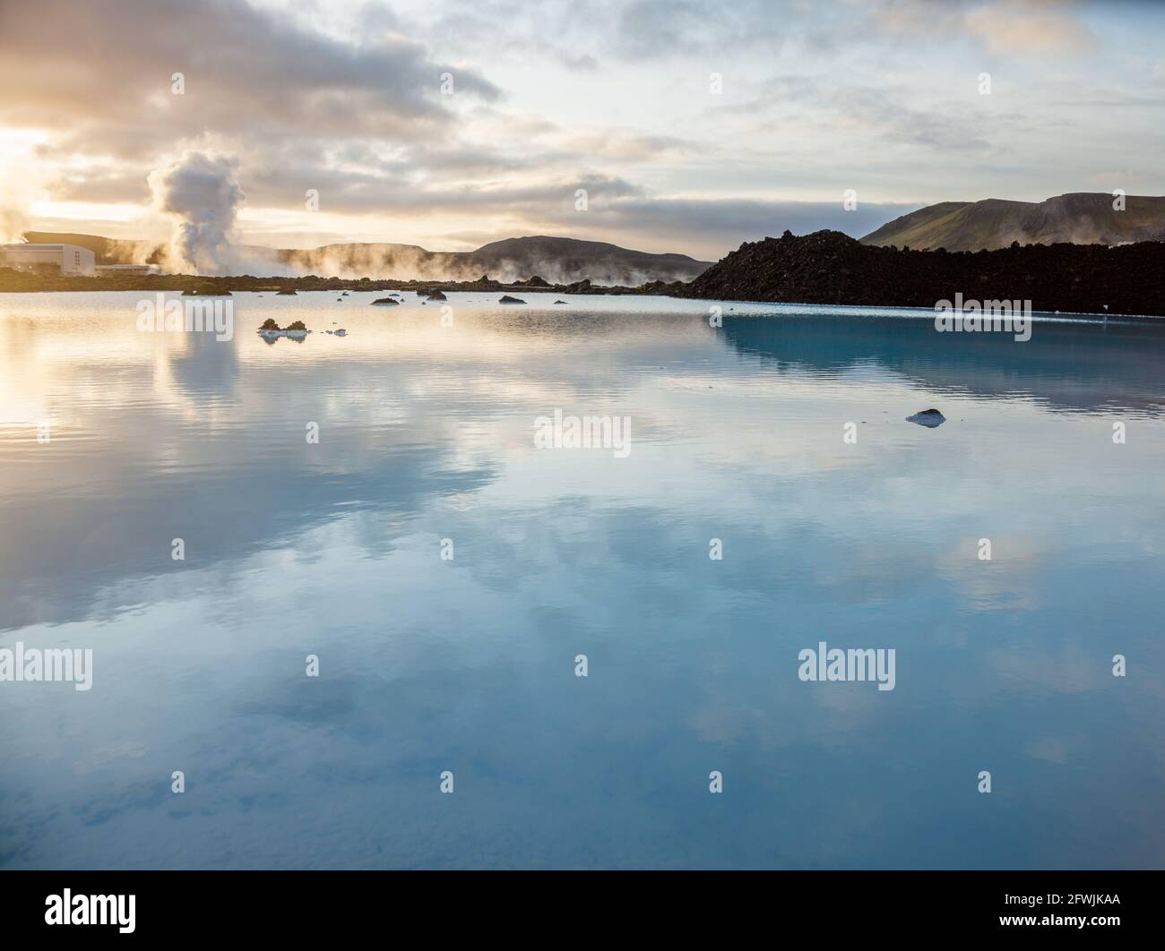 The rich geothermally warmed sea waters and volcanic lava terrain surrounding the Blue Lagoon Resort and Spa at dawn in Iceland Stock Photo