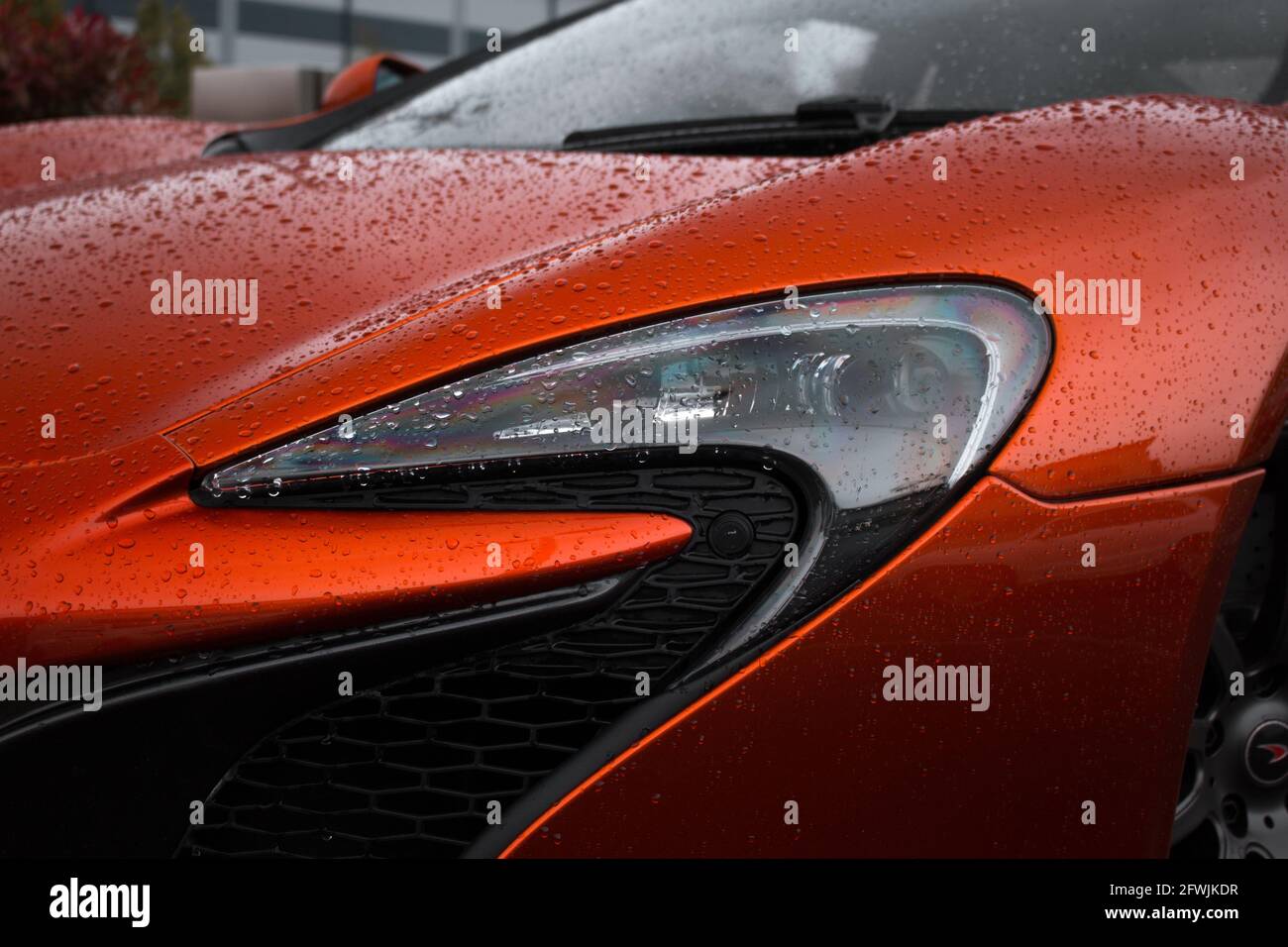 The Front Xenon Headlight Of A Volcano Orange 2015 McLaren 650S Coupe Supercar Stock Photo