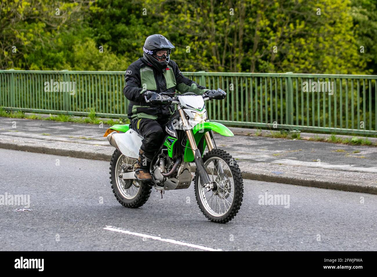 2014 green Kawasaki 449cc Enduro dirt bike Motorbike rider; two wheeled transport, motorcycles, vehicle, roads, motorbikes, motorcycle bike riders motoring in Chorley, UK Stock Photo