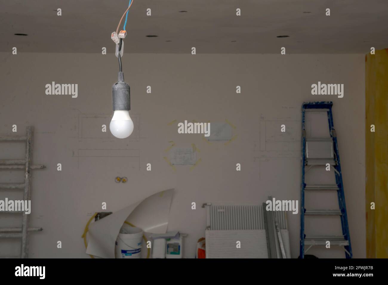 Temporary light at construction site hanging from the ceiling