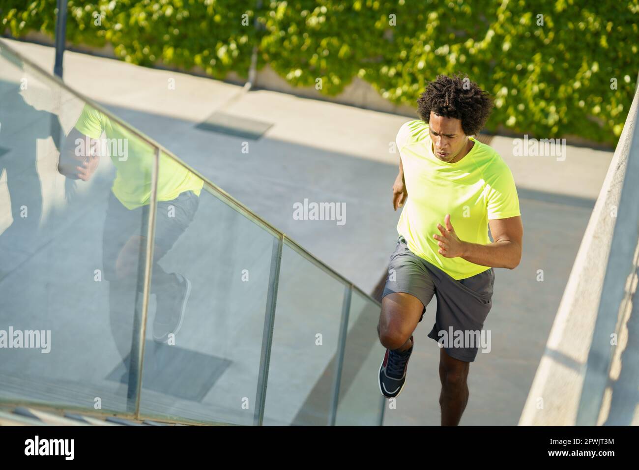 Black man running up stairs hi-res stock photography and images - Alamy