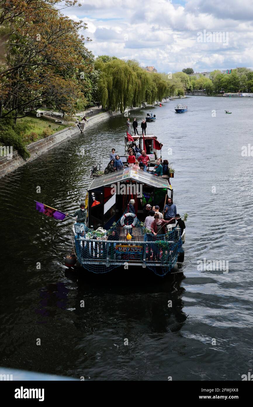 Berlin, Germany. 23rd May, 2021. Participants of a demonstration on water  under the motto "Against the rent madness - now more than ever!" protest on  boats on the Spree. The boat and