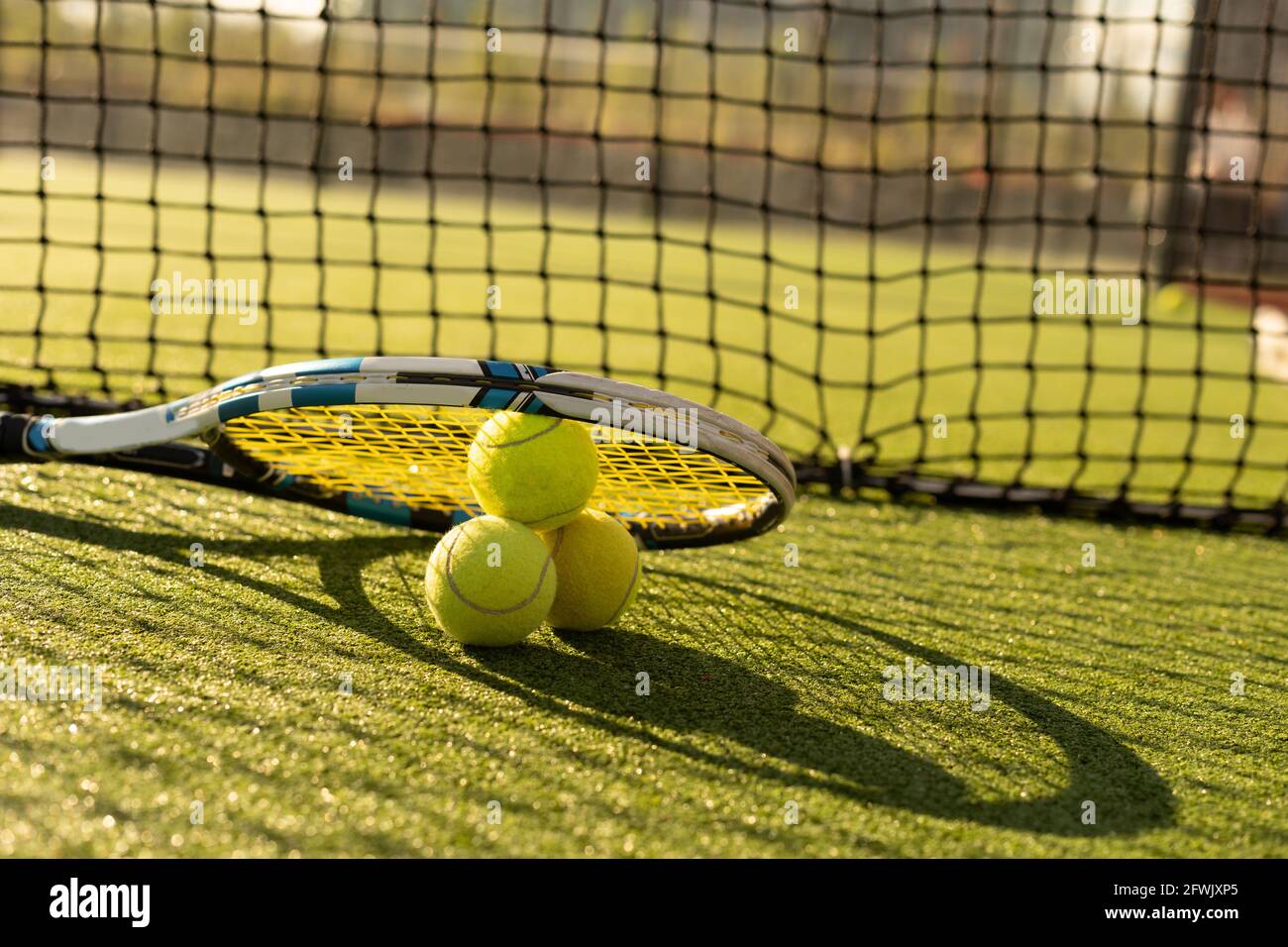 Close up view of two tennis rackets and balls on the tennis court Stock  Photo - Alamy