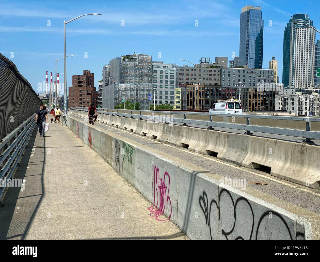 Brooklyn, NY, USA - May 23, 2021: Concrete barriers separating pedestrians, bicyclists and vehicular traffic on Pulaski Bridge Stock Photo