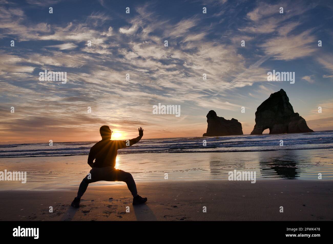 Wellington. 23rd May, 2021. A visitor practises Chinese martial arts at the Wharariki Beach of the Golden Bay tourist site in New Zealand, May 23, 2021. Credit: Zhang Jianyong/Xinhua/Alamy Live News Stock Photo