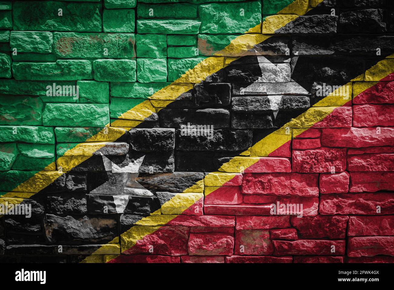 National flag of Saint Kitts and Nevis on stone wall background.The