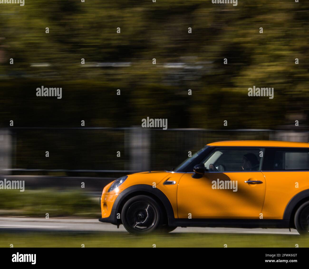 Yellow minicooper on the road Stock Photo