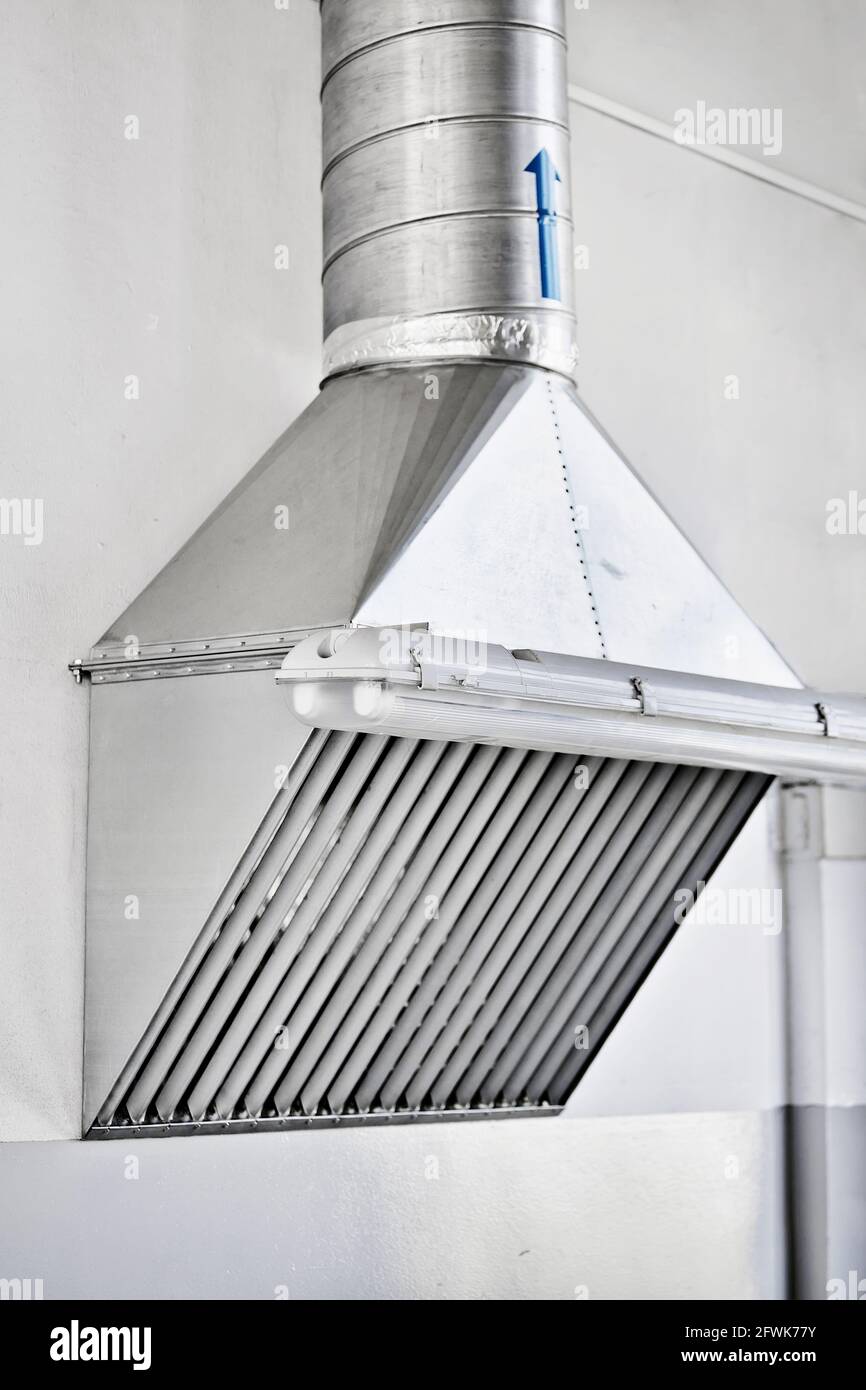 Cooker hood in the production shop. Installation of a ventilation system in industrial premises Stock Photo