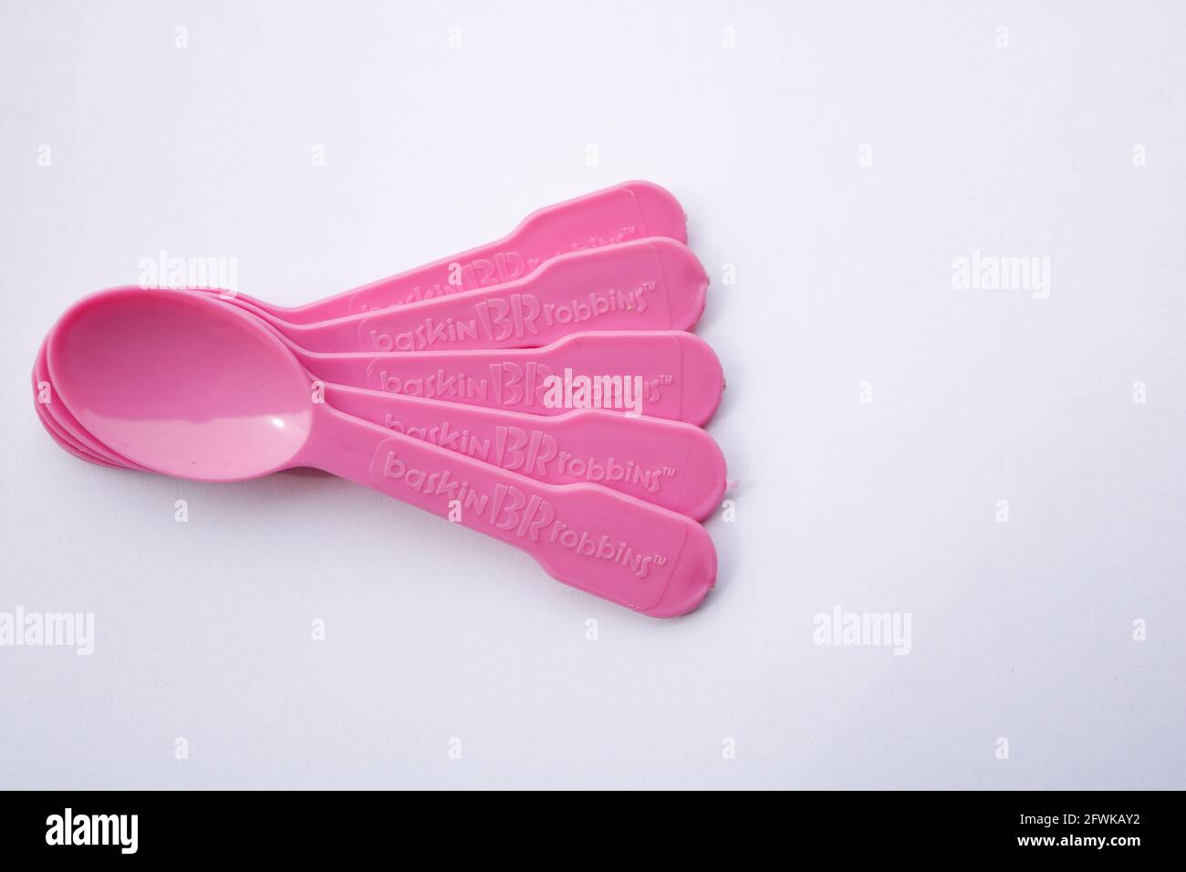 Lahore, Punjab, Pakistan - April 2, 2021: Multiple Plastic spoons from Baskin Robbins on isolated white background with negative space. Stock Photo