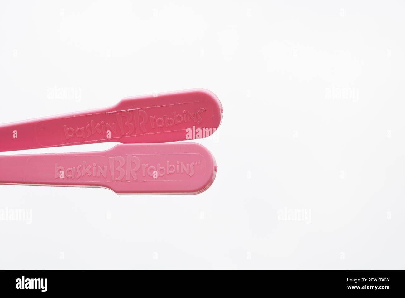 Plastic utensils, Pink plastic spoon on isolated white background Stock Photo