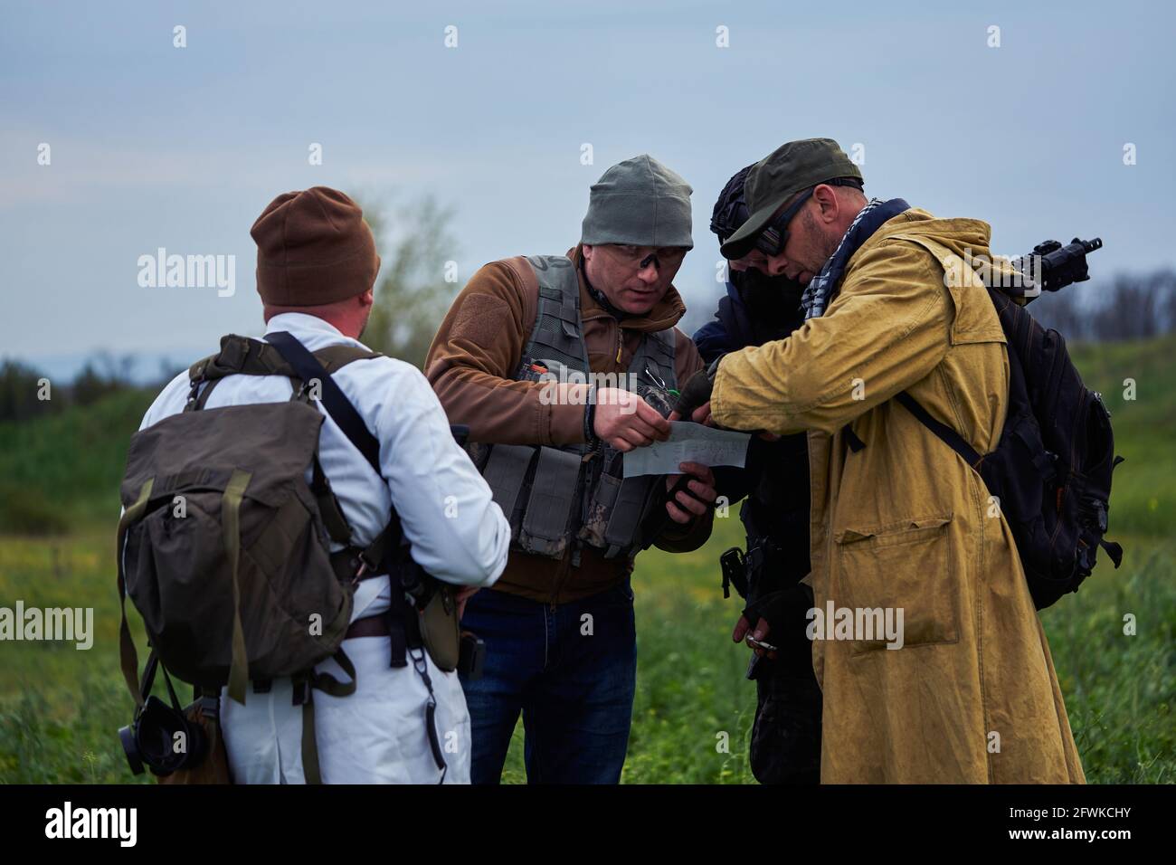 Airsoft players in military uniform watching a map Stock Photo Alamy