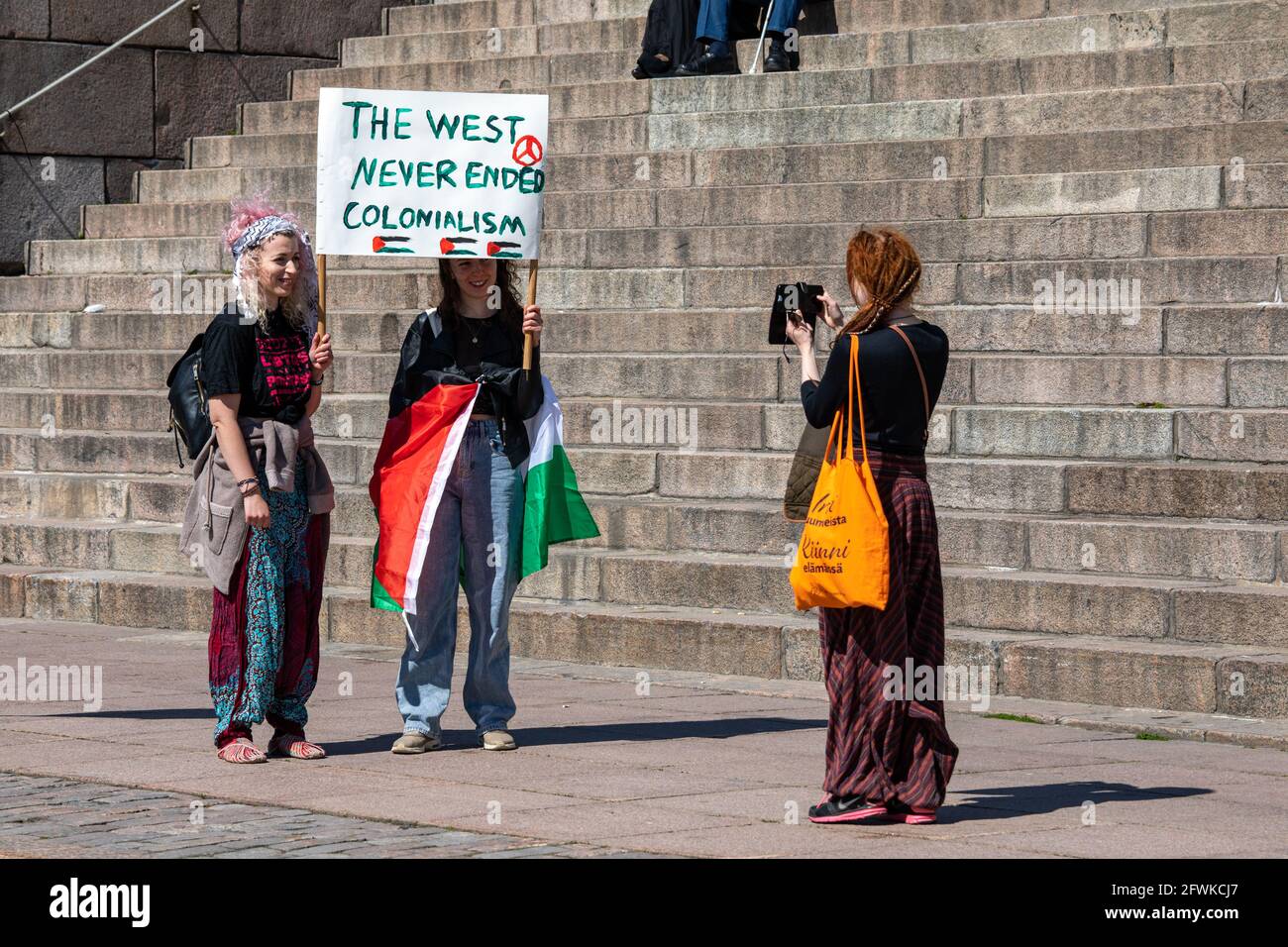Pro-Palestinian demonstrators taking pictures before Solidarity March on behalf of Palestine in Senate Square, Helsinki, Finland Stock Photo