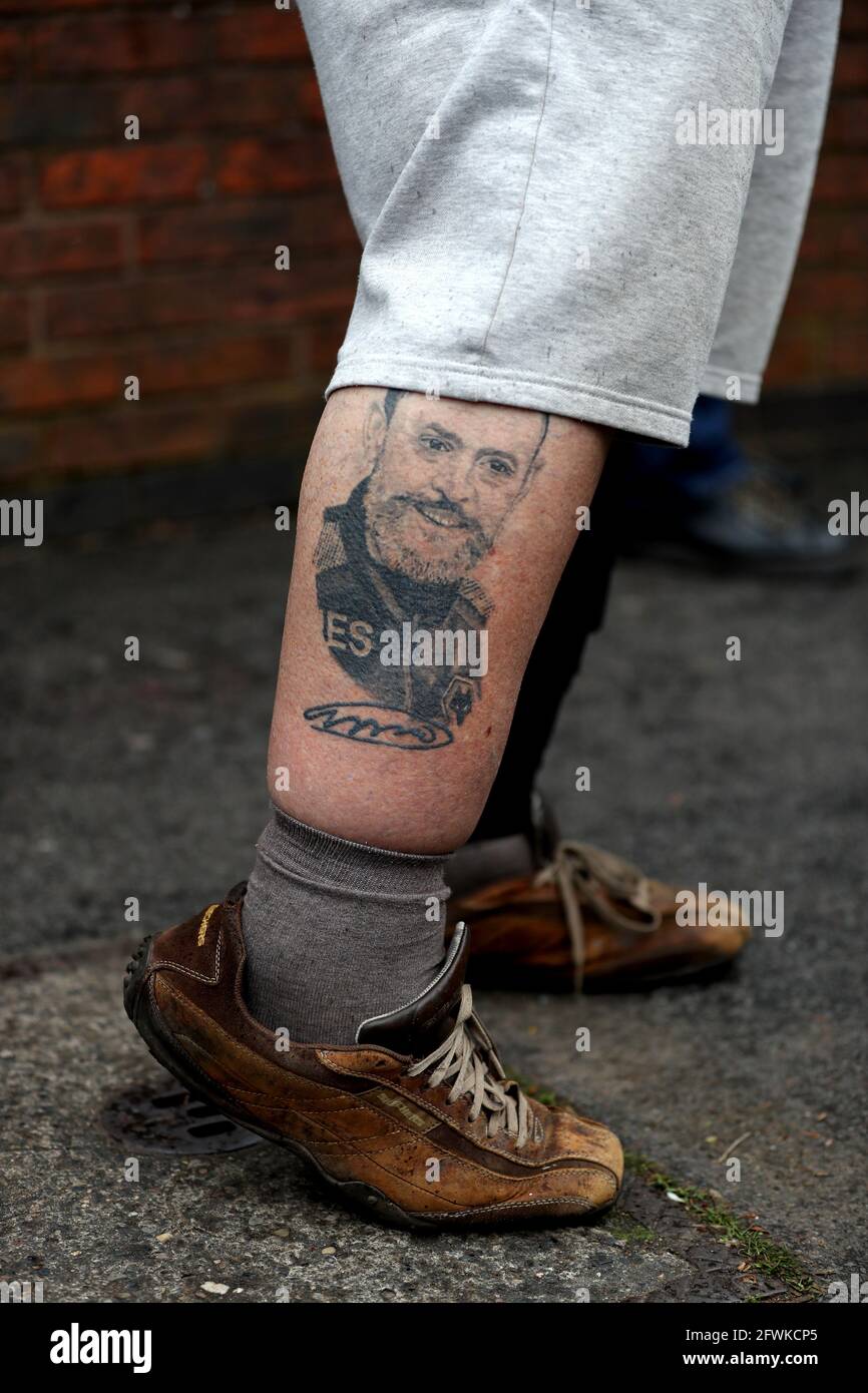 A fan with a tattoo of Wolverhampton Wanderers manager Nuno Espirito Santo on his leg, outside of the stadium ahead of the Premier League match at the Molineux Stadium, Wolverhampton. Picture date: Sunday May 23, 2021. Stock Photo