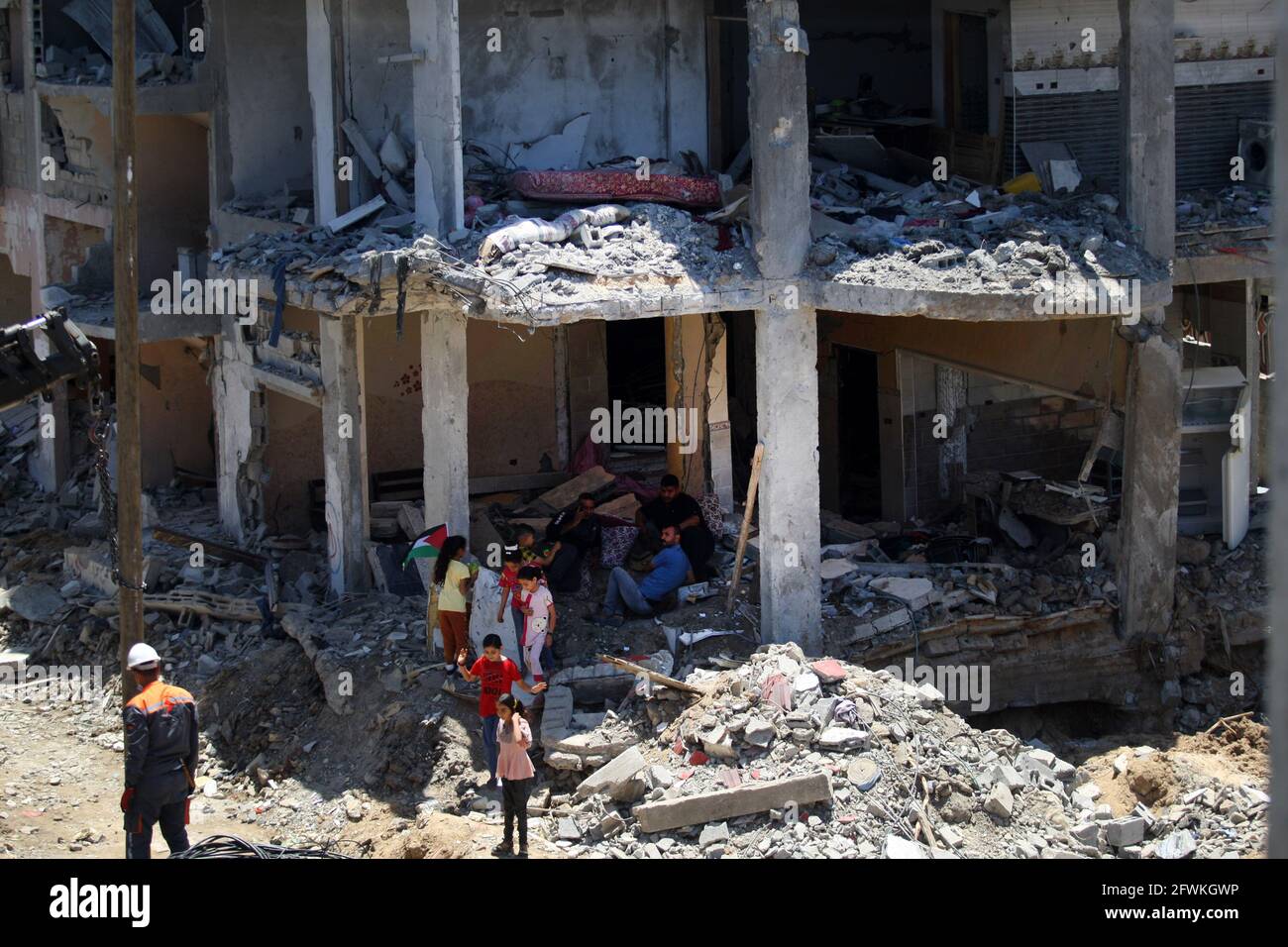 Gaza, Gaza. 23rd May, 2021. Palestinians sit on their destroyed homes, destroyed by Israeli strikes, in Beit Hanun in the northern Gaza Strip on Sunday, May 23, 2021. Gazans tried to piece back their lives, after a devastating 11-day conflict with Israel that killed more than 240 people and made thousands homeless in the impoverished Palestinian enclave. Photo by Ismael Mohamad/UPI Credit: UPI/Alamy Live News Stock Photo