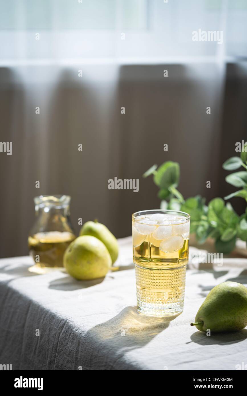 Glass of pear fresh juice or cider and fresh pears on rustic background ...