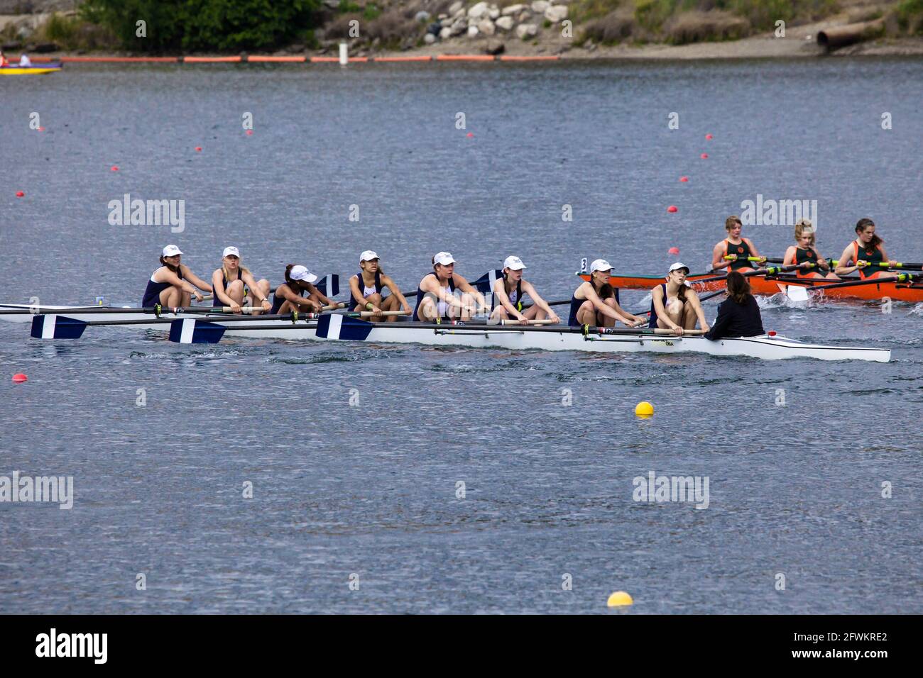 Young women's eight rowing teams in close race at Lake Natoma, California Stock Photo