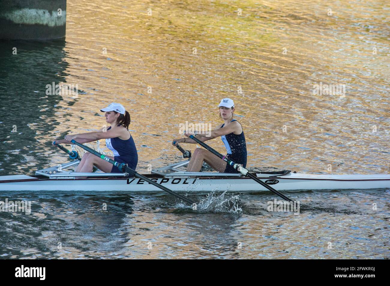 Young women's double sculls rowing in early morning regatta at Port of Sacramento, California Stock Photo