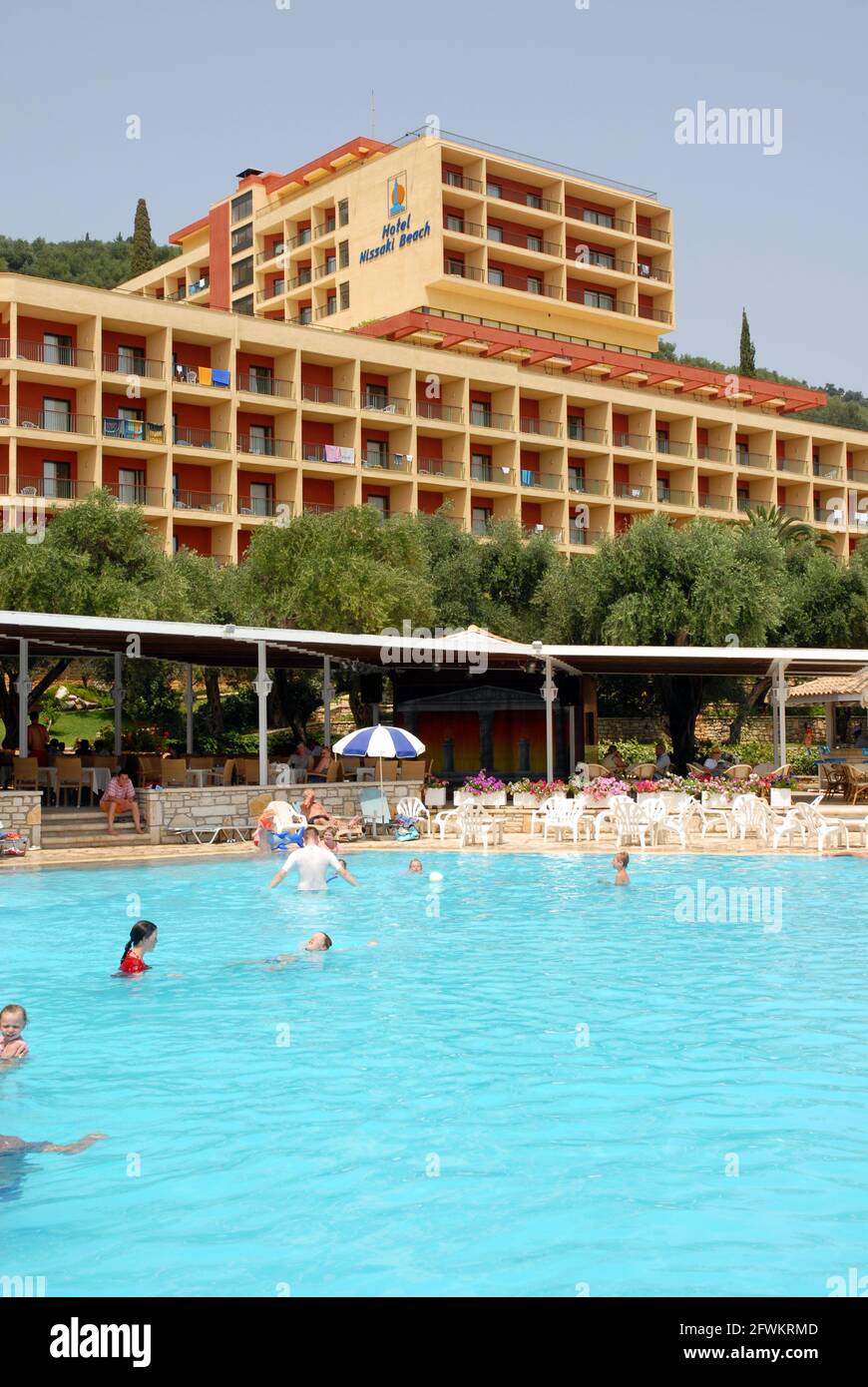 People enjoying a casual swim in the hotel pool, Nissaki Beach, Corfu, Greece Stock Photo