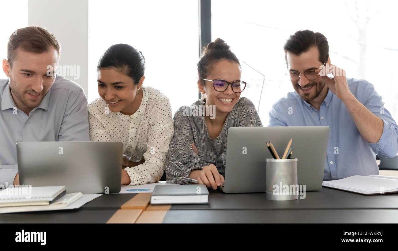 Happy diverse colleagues working on project together, brainstorming ...