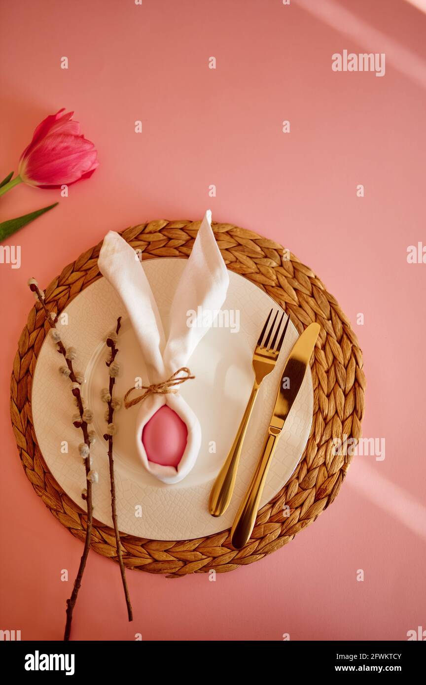 Blooming tulip, easter egg on plate and tableware Stock Photo