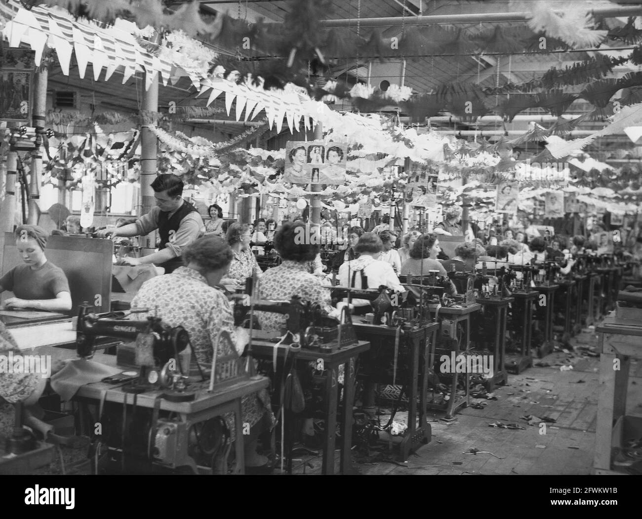 1953, historical, female workers sitting at their sewing machines on
