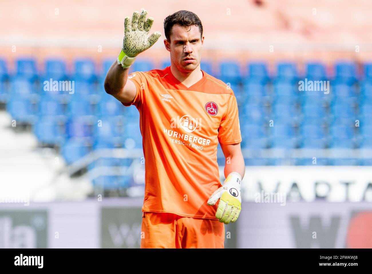 Hanover, Germany. 23rd May, 2021. Football: 2. Bundesliga, Hannover 96 - 1. FC Nürnberg, 34. matchday at HDI Arena. Nuremberg goalkeeper Christian Mathenia raises his hand on the pitch. Credit: Hauke-Christian Dittrich/dpa - IMPORTANT NOTE: In accordance with the regulations of the DFL Deutsche Fußball Liga and/or the DFB Deutscher Fußball-Bund, it is prohibited to use or have used photographs taken in the stadium and/or of the match in the form of sequence pictures and/or video-like photo series./dpa/Alamy Live News Stock Photo