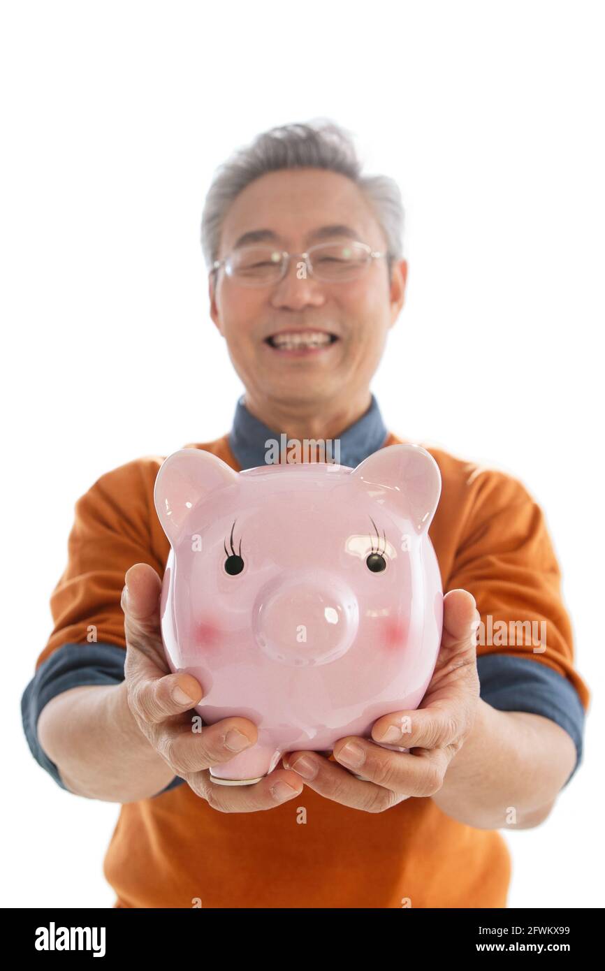 Happy old man with a piggy bank Stock Photo - Alamy
