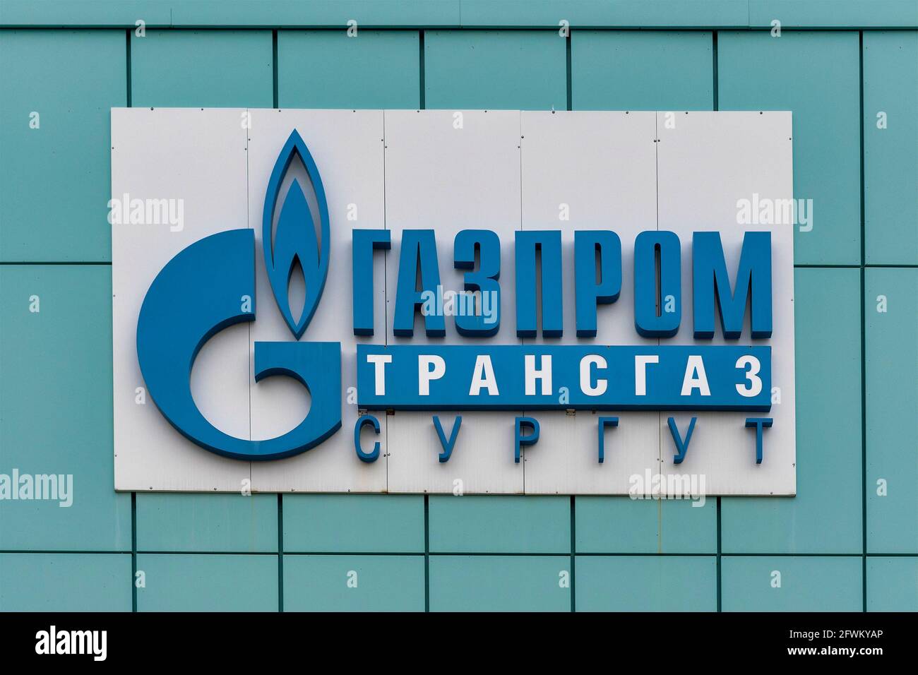 Logo is written in Russian language of Surgut Gasprom Transgas. Surgut, Russia - 17, May 2021. Stock Photo