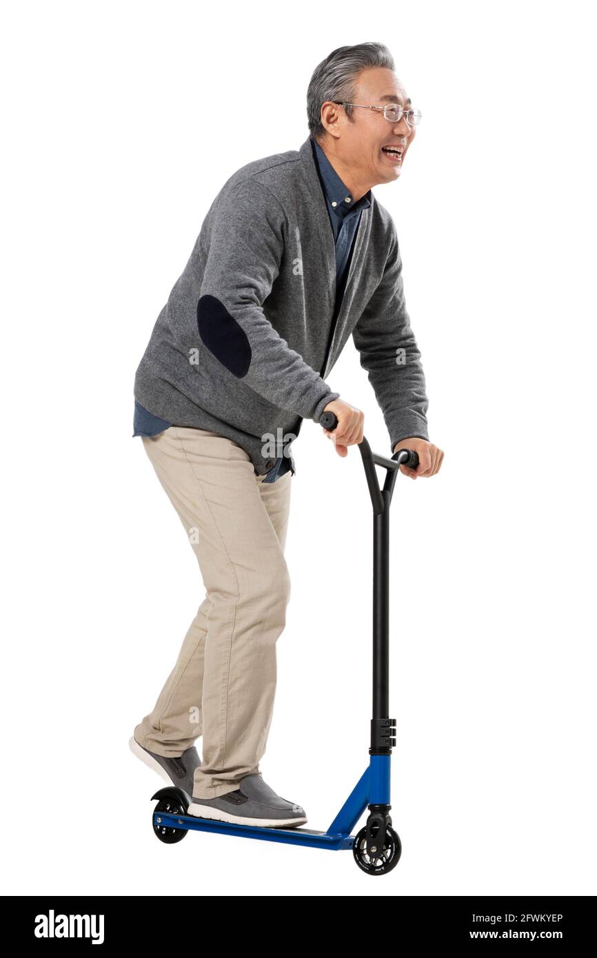 Happy old people playing scooter Stock Photo Alamy