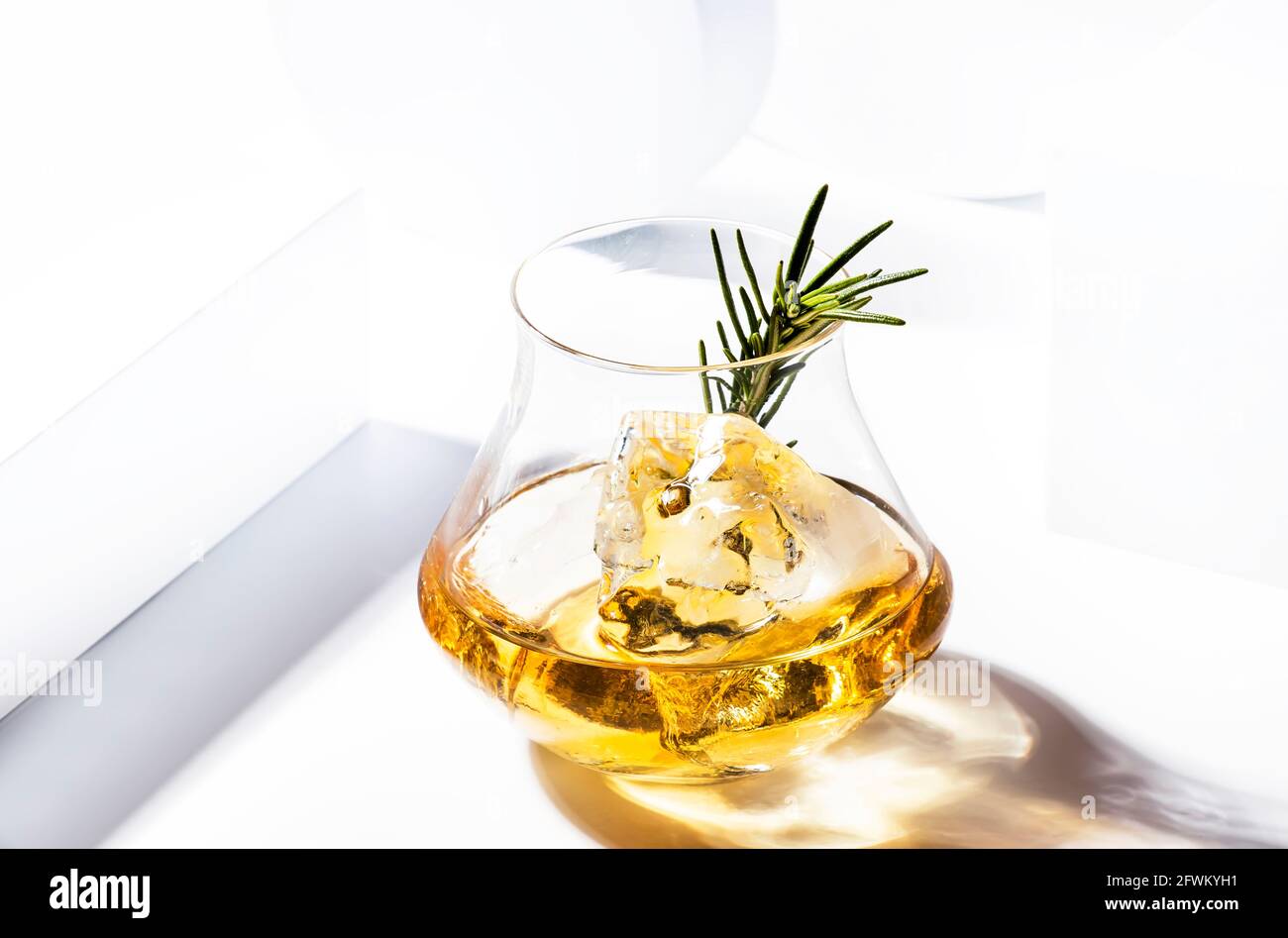 https://c8.alamy.com/comp/2FWKYH1/whiskey-scotch-or-bourbon-glass-with-rosemary-shard-ice-on-black-white-background-with-geometric-cubes-and-circles-contemporary-still-life-2FWKYH1.jpg