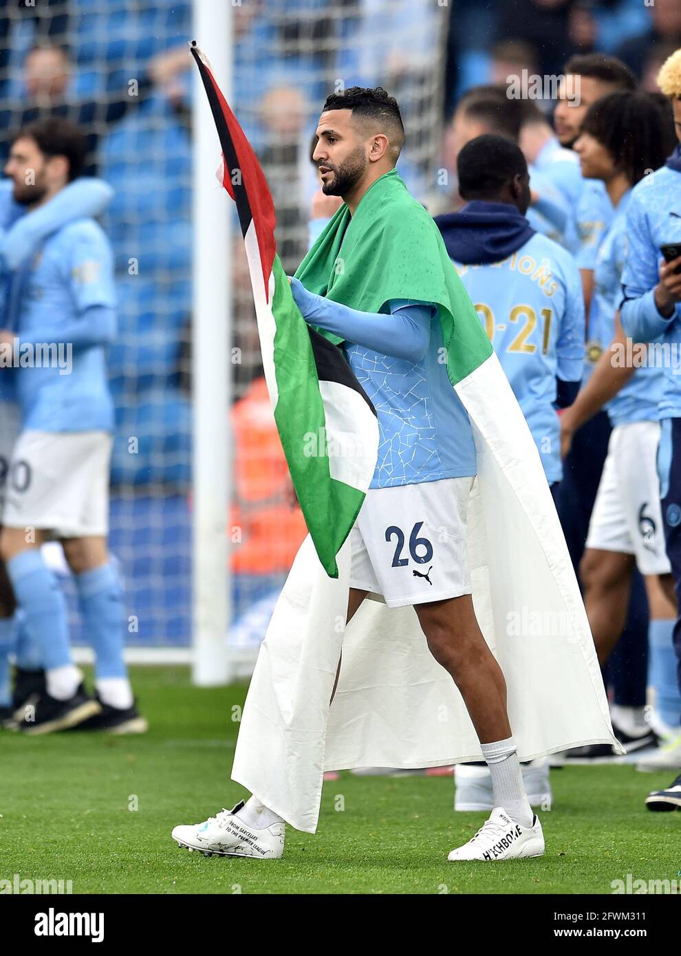 Manchester City's Riyad Mahrez with the Flag of Algeria after the Premier League match at the Etihad Stadium, Manchester. Picture date: Sunday May 23, 2021. Stock Photo