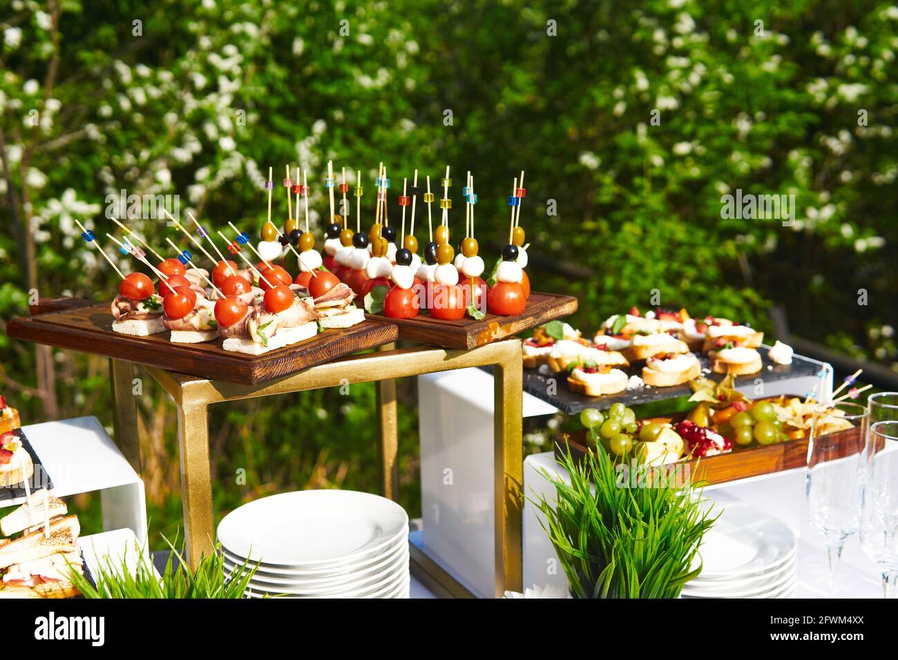 buffet in the open air table with canapes on cocktail sticks against