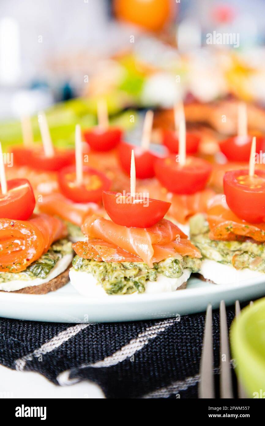 Canapes with red fish, pesto and cherry tomatoes Stock Photo Alamy